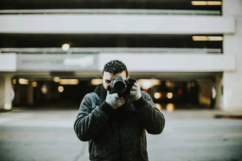 Person capturing photo using smartphone in city enhanced by photo editors